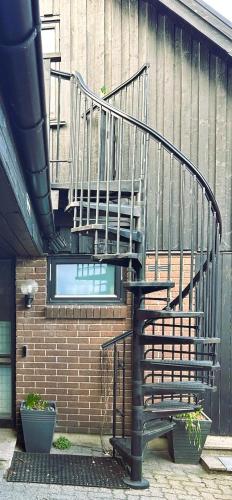 a spiral staircase on the side of a building at En trappa upp in Malmö