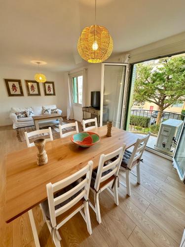 a dining room with a large wooden table and chairs at Cœur de St Tropez in Saint-Tropez