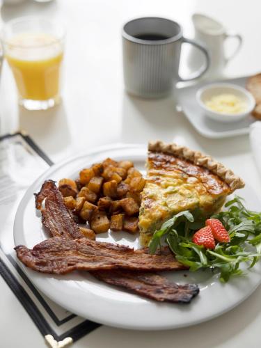 a plate of breakfast food with toast and bacon at Lakehouse Inn in Lee