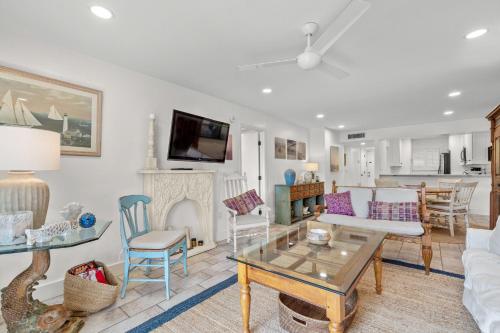 a living room with a couch and a table at Modern beachfront condo in Sarasota