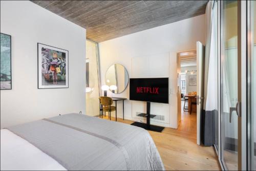 a bedroom with a bed and a television in it at WHome | LS48 Prime Location Upscale Family Apartment in Lisbon