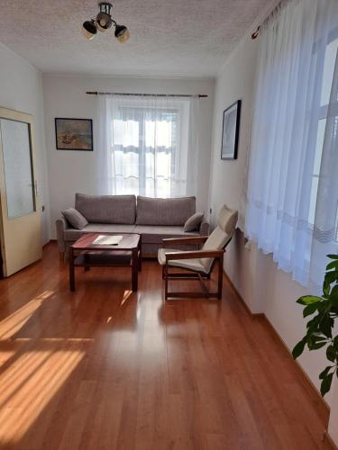 a living room with a couch and a table at Apartmán U Rogala in Děčín