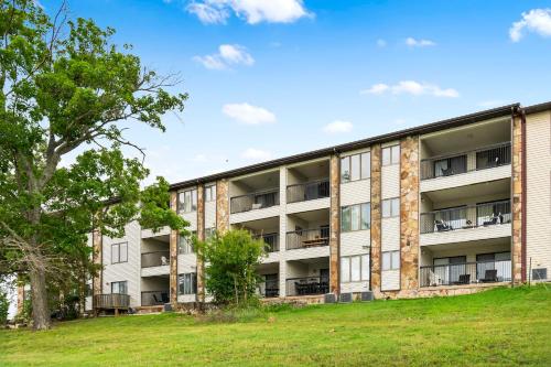 an apartment building with a grass field in front of it at The Fishin Hole in Kimberling City