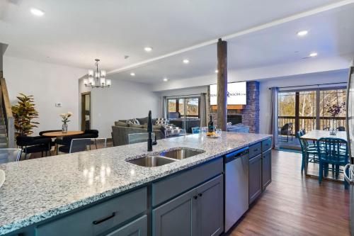 a kitchen with a sink and a living room at Multiple Arcades-Private Hot Tub-Cmty Indoor Pool-Free Daily Tickets-Water View-Cmty Dog Park in Hollister
