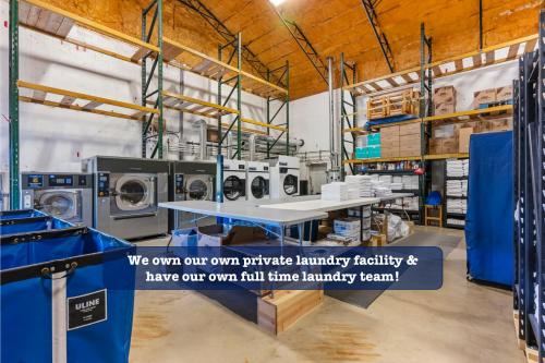 a laundry room with washing machines and a table at Multiple Arcades-Private Hot Tub-Cmty Indoor Pool-Free Daily Tickets-Water View-Cmty Dog Park in Hollister