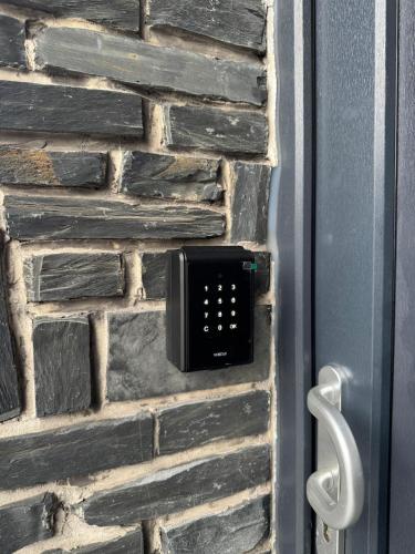 a brick wall with a alarm clock on it at Casa MG in Ans