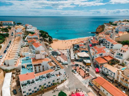 an aerial view of a town with a beach at Hotel Carvoeiro Plaza in Carvoeiro