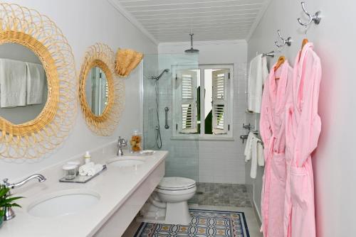 a bathroom with a sink and a toilet and a mirror at Cobblers Cove - Barbados in Saint Peter