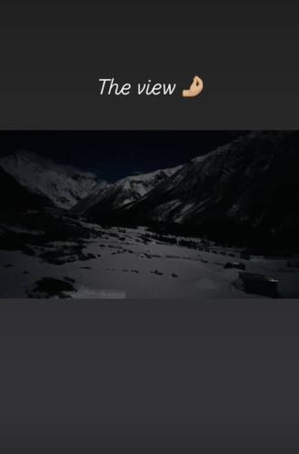 a view of a mountain with a moon in the sky at Memories homestay in Chitkul
