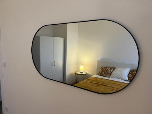 a mirror reflection of a bedroom with a bed and a bed at Sassy in Belgrade