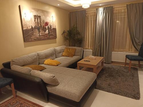 a living room with a couch and a table at Cosy house with 3 rooms and garden near beach in Ostend