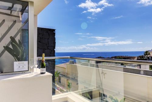 a balcony with a view of the ocean at SEA VIEW I POOL I PRIVATE GARAGE I WI-FI I GRILL I WINE l COFFEE in San Miguel de Abona