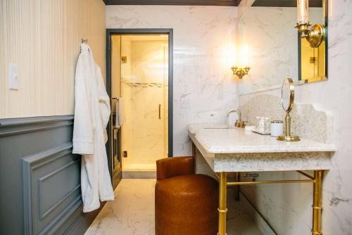 a bathroom with a sink and a mirror at The Drake Oak Brook, Autograph Collection in Oak Brook