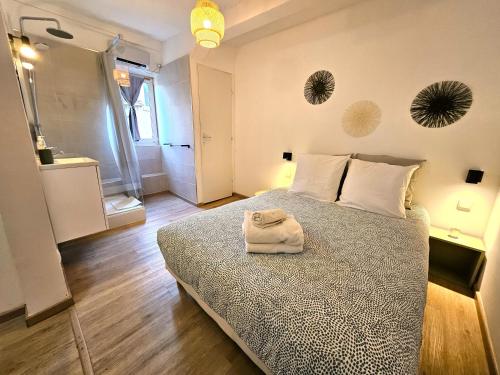 a bedroom with a bed with a towel on it at Studio- Hyper Centre Ville in Colmar