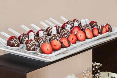 a tray of chocolates and strawberries on a table at Sonesta Hotel El Olivar in Lima
