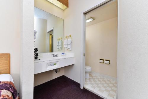 a bathroom with a sink and a toilet at America's Best Value Inn & Suites, Atlanta - Morrow in Morrow