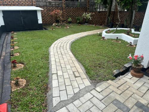a brick walkway in a yard with a yard at Bungalows by CPC in Kandy