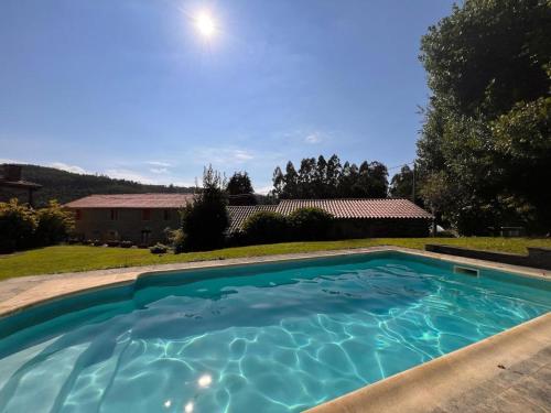 a swimming pool in the backyard of a house at Prioral Countryside Villa in Miño