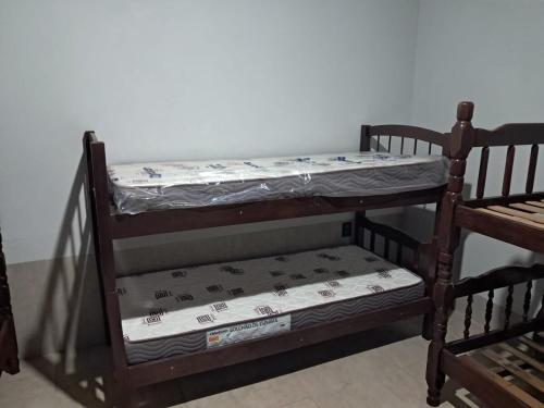 a wooden bunk bed with a mattress on it at Casa de festa para festa do peao de barretos in Barretos
