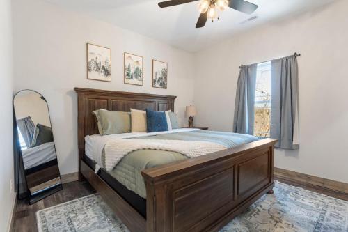a bedroom with a bed and a ceiling fan at All New Cabin w Free Attraction Tickets-Pvt Hot Tub-Community Indoor Pool in Hollister