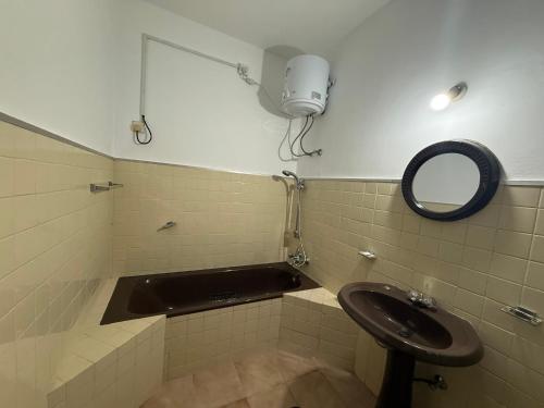 a bathroom with a sink and a mirror at Bungalows by CPC in Kandy