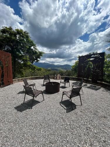 a group of chairs and a fire pit on a patio at Casa de Montanha Quinta do Alto in Aiuruoca
