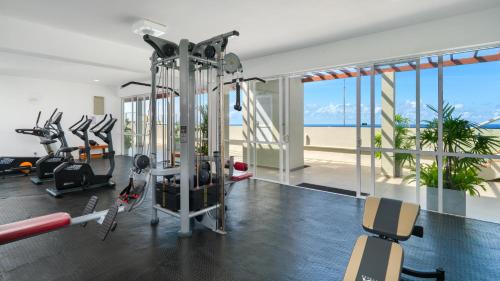 a gym with treadmills and ellipticals in a building at Luxury Beachfront Stay - Sheki Sands in Wattala