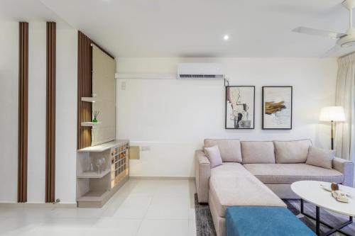 a living room with a couch and a table at Luxury Beachfront Stay - Sheki Sands in Wattala