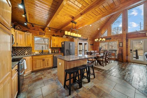 a kitchen with wooden cabinets and a bar with stools at Todd Escape in Todd