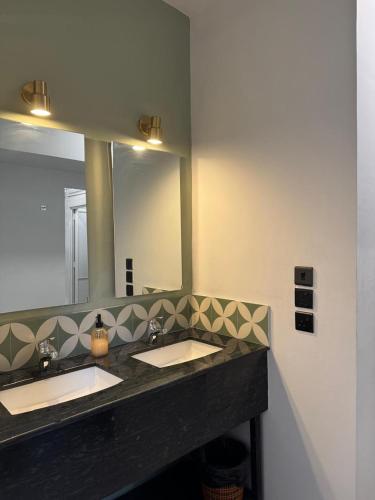 a bathroom with two sinks and a large mirror at CityRest Fort in Colombo