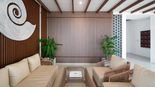 a living room with two couches and a coffee table at Luxury Beachfront Stay - Sheki Sands in Wattala