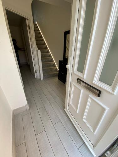 an empty hallway with a door and stairs at Winter double bedroom in Stone Grove