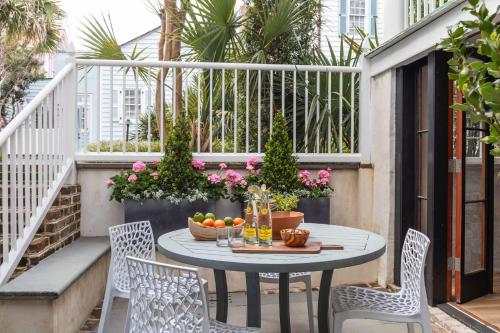 a small patio with a table and chairs at The Courtyard at CasaZoe in Charleston