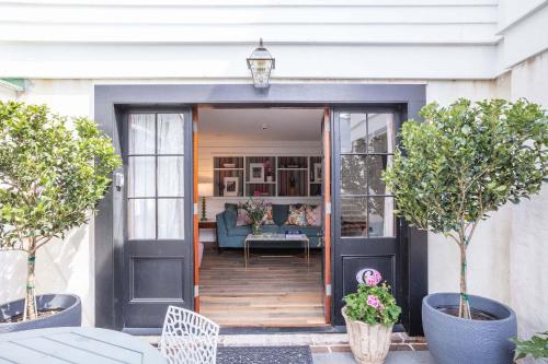 an entrance to a house with a black door at The Courtyard at CasaZoe in Charleston