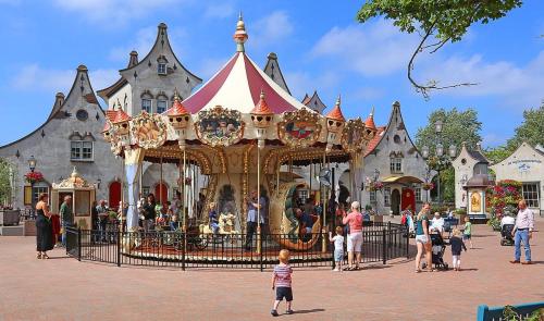 a child standing in front of a carousel at a carnival at Beach villa at the IJsselmeer 8p in Enkhuizen