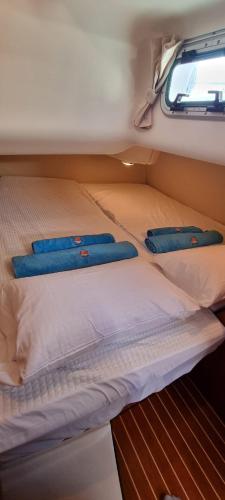 a bed with two blue pillows on top of it at Velero Passionetenerife in San Miguel de Abona
