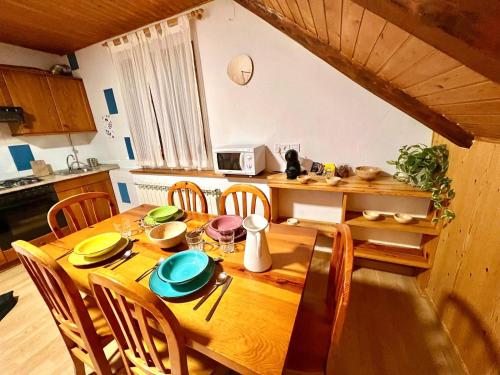 a dining room table with chairs and a wooden tableablish at Apartamento La Buhardilla del Boscache in San Juan de Plan