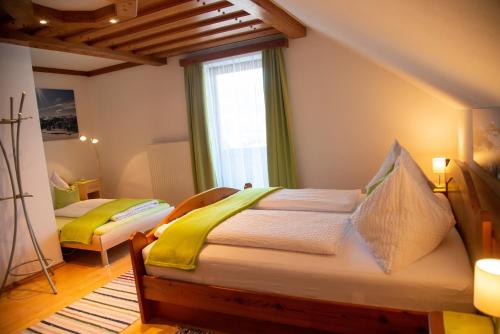 a bedroom with two beds and a window at Apartement Seifterhof in Sankt Andrä im Lungau