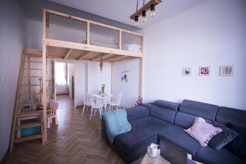 a living room with a couch and a loft bed at Apartament Antresola Przemyśl in Przemyśl