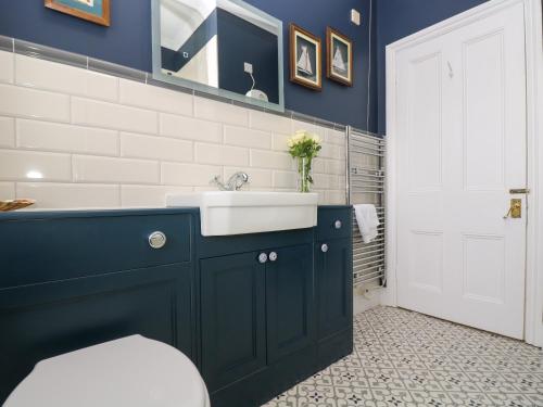 a bathroom with a sink and a blue wall at Mount View in Marazion
