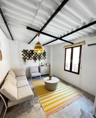 a living room with a couch and a table at El Secreto de Lanjarón in Lanjarón