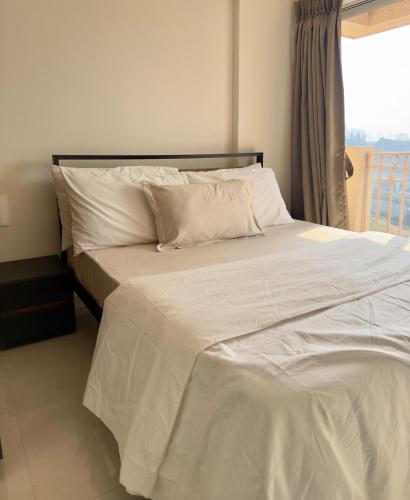 a bed with white sheets and pillows in a bedroom at Your Ultimate Edge Awaits! in Thane