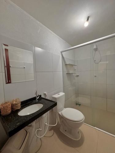 a bathroom with a toilet and a sink and a shower at Casa du Vento in Cruz