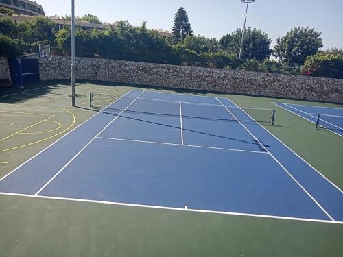a tennis court with two tennis rackets on it at Caesarea Vacation Rooms in Caesarea
