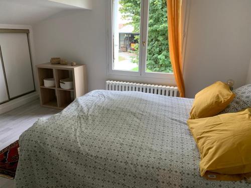 a bedroom with a bed and a window at Les Vendanges Maison Vigneronne in Reuilly