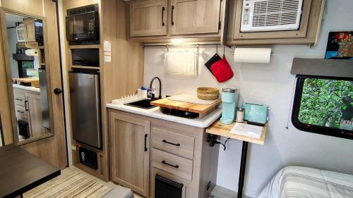 a small kitchen in an rv with a sink at The Owl House in Spring Valley