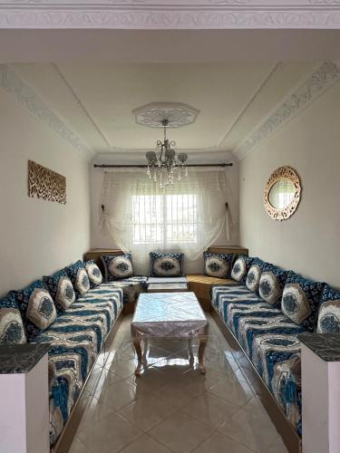 a living room with couches and a table at Noor Home in Chefchaouen
