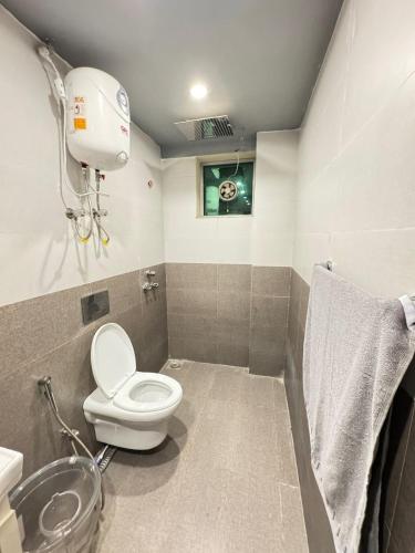 a bathroom with a toilet and a sink at Relax Under the Stars 1BHK in Lahore