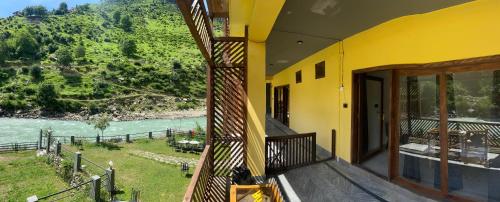 a balcony of a house with a view of a river at Bono Apartments in Nārān