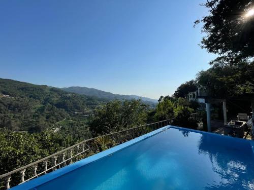 a swimming pool with a view of the mountains at Casa d'Além - Gerês in Terras de Bouro
